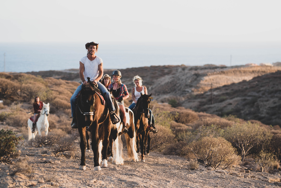 People Riding Horses in the Desert